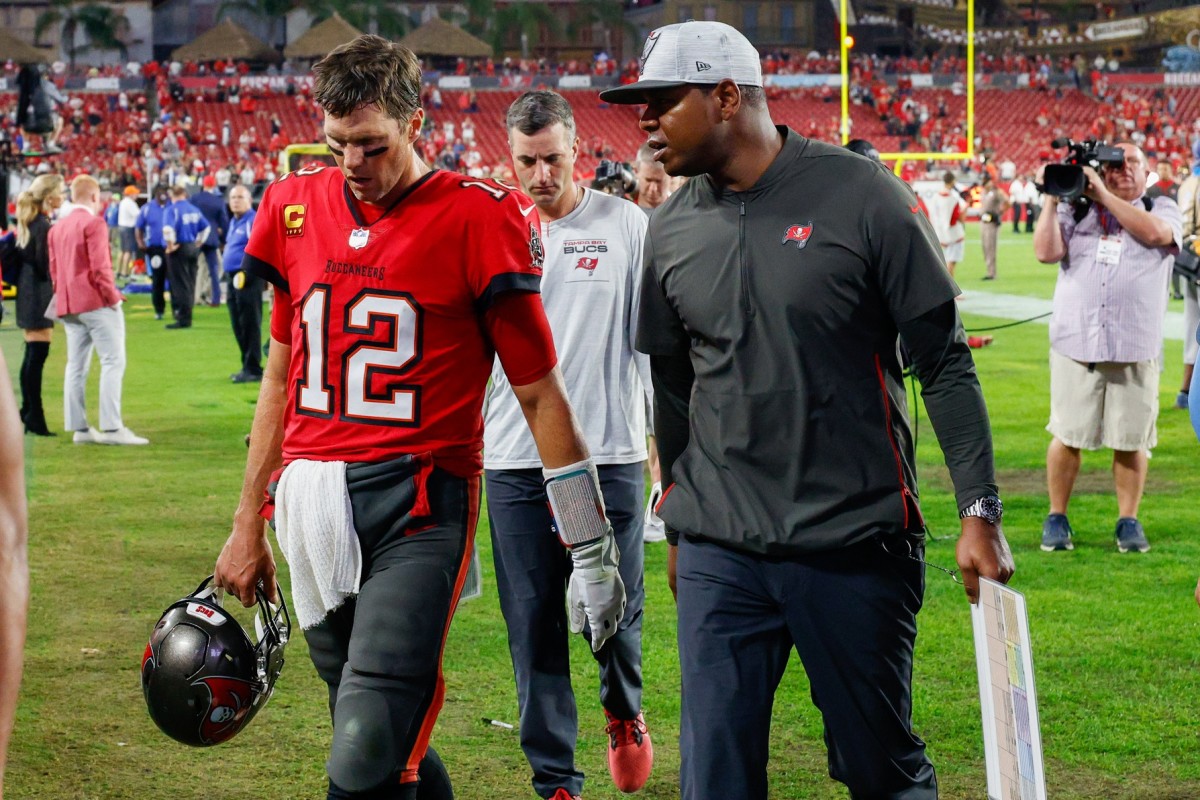 Tampa Bay Buccaneers quarterback Tom Brady (12) and offensive coordinator Byron Leftwich (right) leave the game against the New Orleans Saints at Raymond James Stadium.