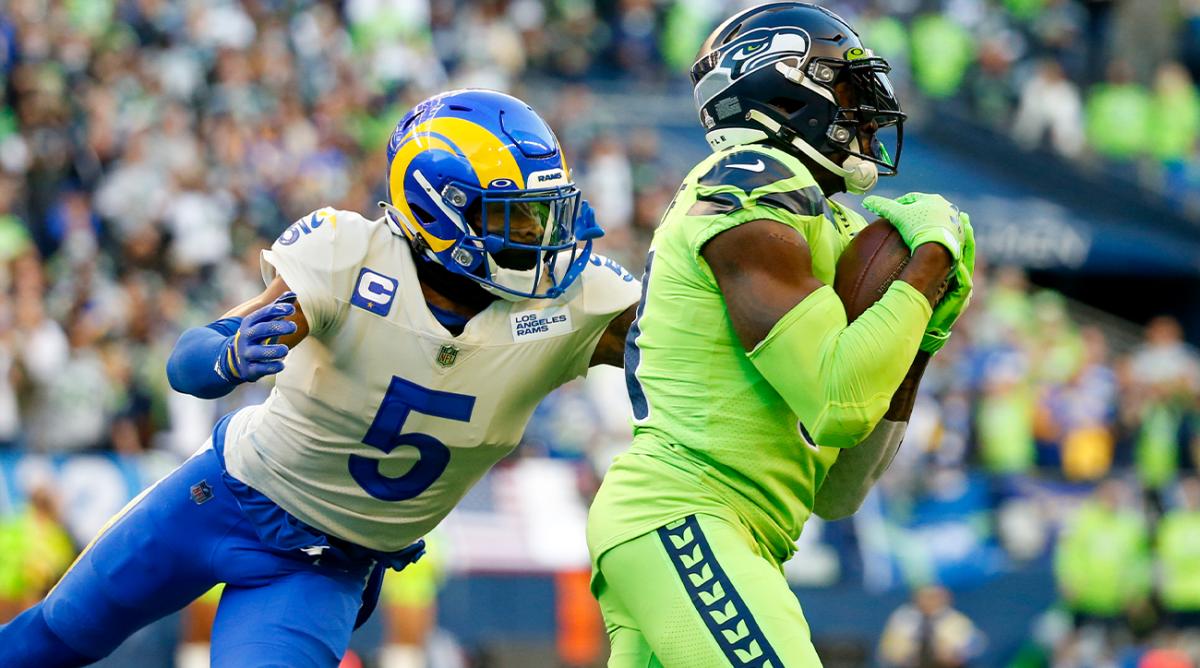 Oct 7, 2021; Seattle, Washington, USA; Seattle Seahawks wide receiver DK Metcalf (14) catches a pass against Los Angeles Rams cornerback Jalen Ramsey (5) during the first quarter at Lumen Field.