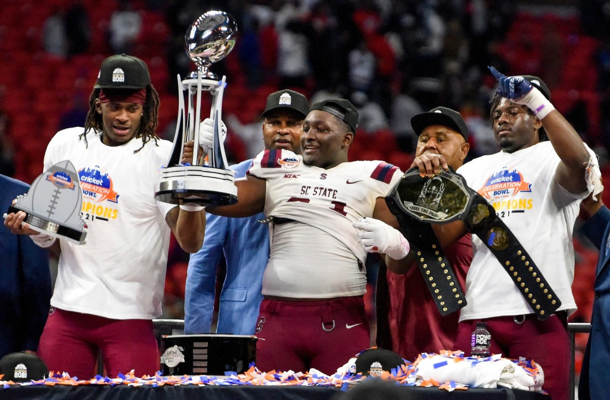South Carolina State players lift their trophy after defeating Jackson State University in the Celebration Bowl in Atlanta, Ga., on Saturday December 18, 2021. Cb51
