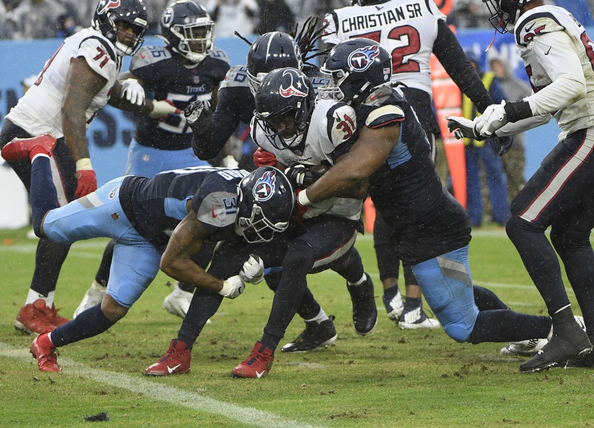 Tennessee Titans free safety Kevin Byard (31) and Tennessee Titans defensive tackle Jeffery Simmons (98) tackle Houston Texans running back David Johnson (31) just after he crosses out of the end zone during the second half at Nissan Stadium.