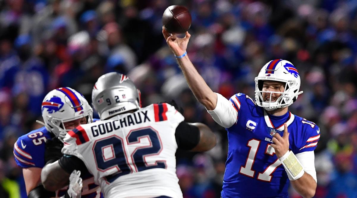 Buffalo Bills quarterback Josh Allen (17) passes over New England Patriots nose tackle Davon Godchaux (92) who is blocked by Bills' Ike Boettger (65) during the first half of an NFL football game in Orchard Park, N.Y., Monday, Dec. 6, 2021.