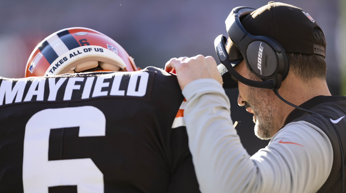 Cleveland Browns head coach Kevin Stefanski talks with quarterback Baker Mayfield (6) during the first quarter against the Baltimore Ravens at FirstEnergy Stadium.