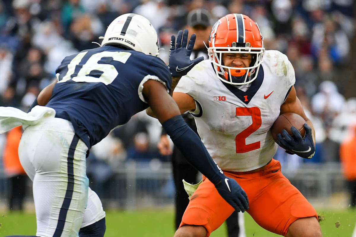 Illinois Fighting Illini running back Chase Brown (2) runs with the ball as Penn State Nittany Lions safety Ji'Ayir Brown (16) defends in overtime at Beaver Stadium. (Rich Barnes-USA TODAY Sports)