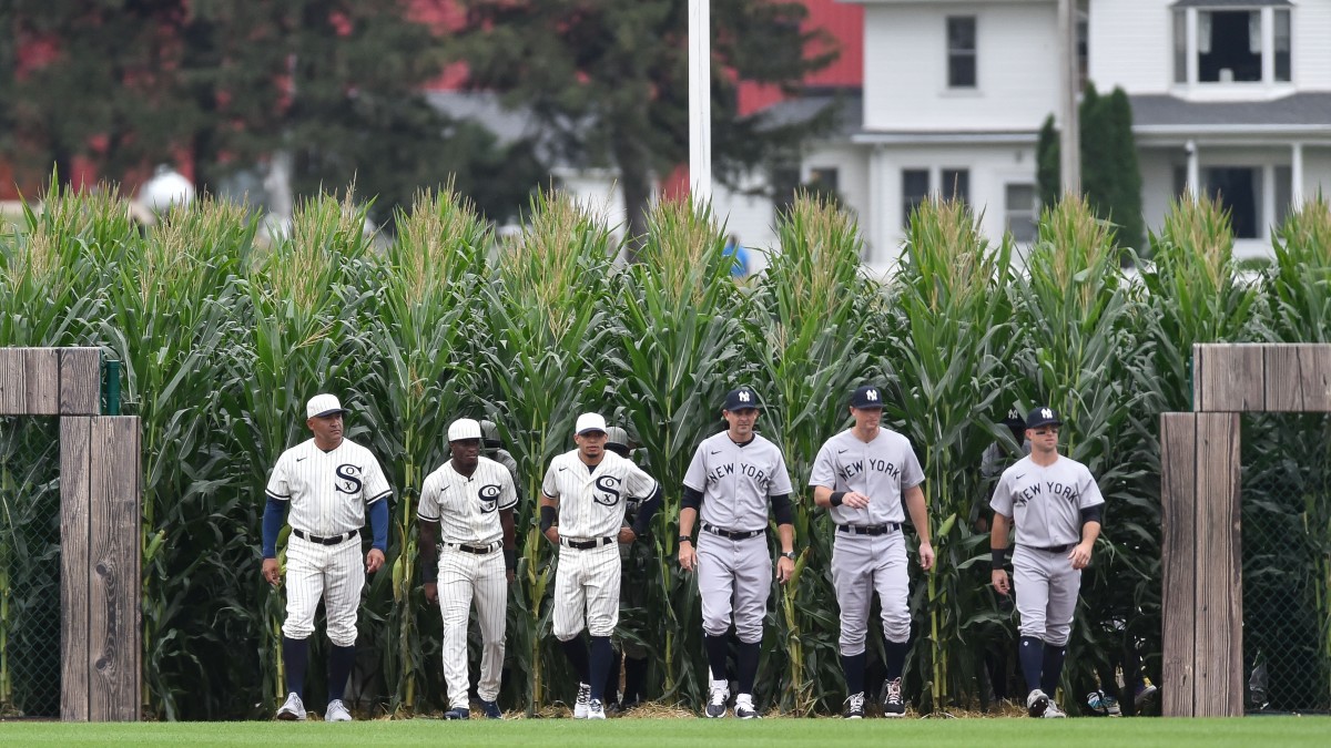 Players from the White Sox and Yankees enter the field through the cornrows.