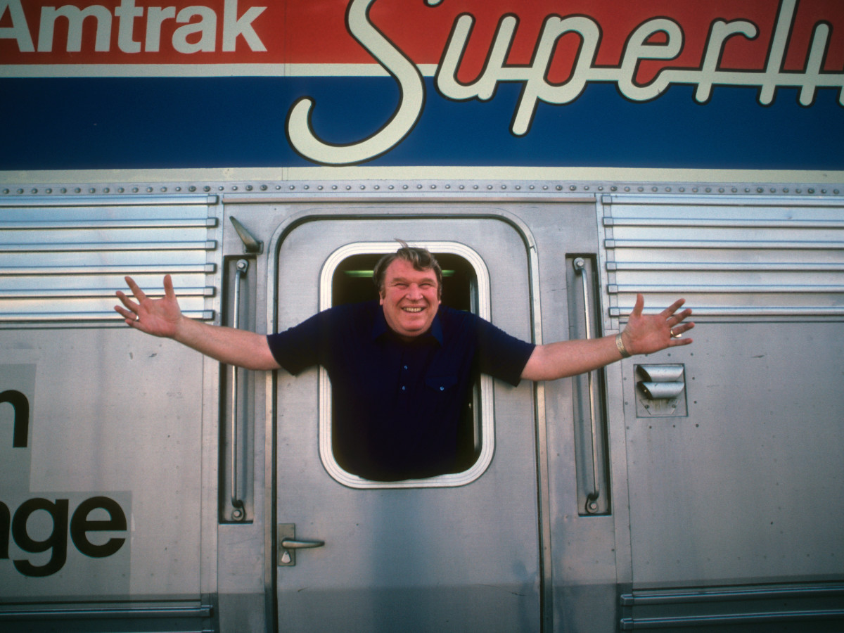CBS broadcaster and former Oakland Raiders coach John Madden posing on Amtrak train