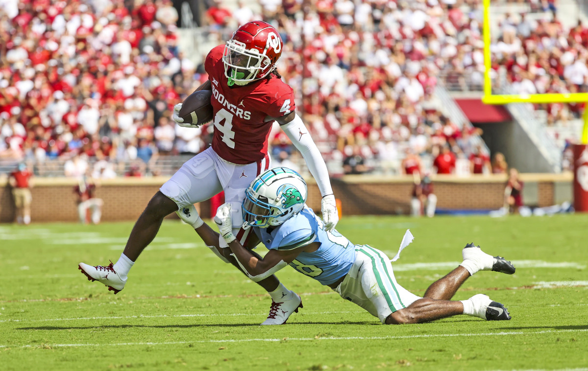 Oklahoma Sooners wide receiver Mario Williams (4) runs with the ball as Tulane Green Wave defensive back Jadon Canady (28) defends.