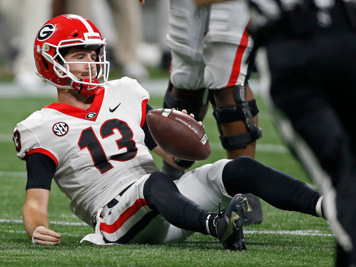 Stetson Bennett lays on the ground after being tackled by Alabama