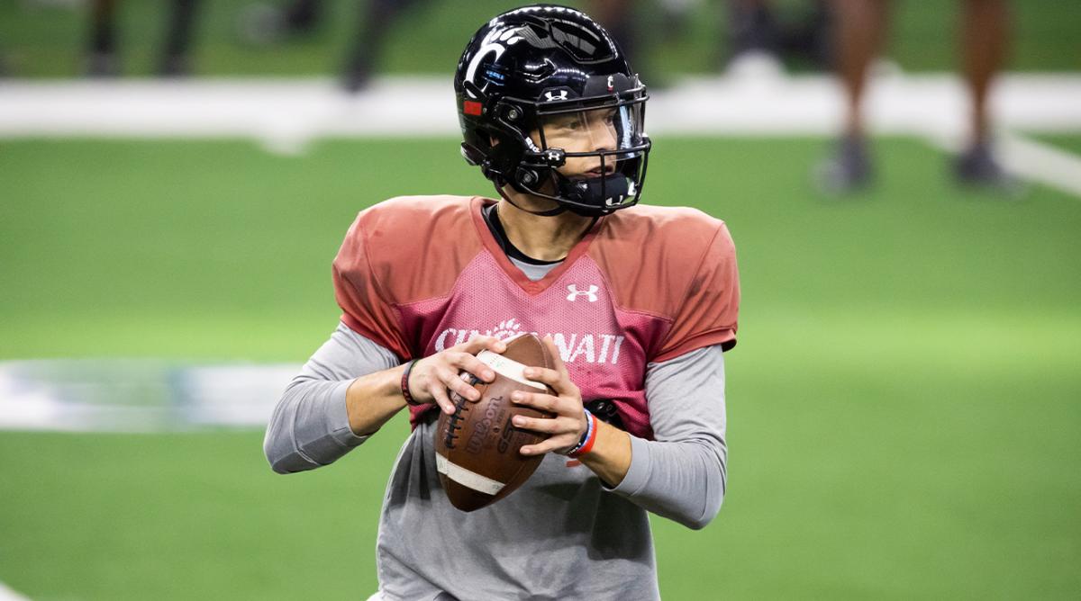 Cincinnati quarterback Desmond Ridder looks for an open receiver during practice for the Cotton Bowl NCAA football game, Monday, Dec. 27, 2021, in Arlington, Texas.