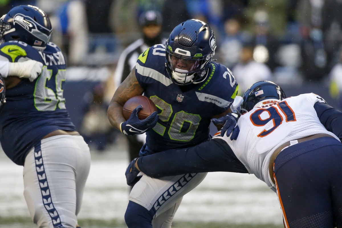 Dec 26, 2021; Seattle, Washington, USA; Seattle Seahawks running back Rashaad Penny (20) rushes against the Chicago Bears during the fourth quarter at Lumen Field. Mandatory Credit: Joe Nicholson-USA TODAY Sports