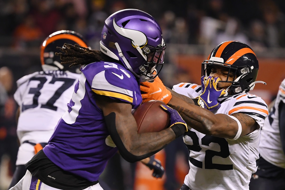 Dec 20, 2021; Chicago, Illinois, USA; Minnesota Vikings running back Dalvin Cook (33) stiff arms Chicago Bears cornerback Kindle Vildor (22) in the second half at Soldier Field. Mandatory Credit: Quinn Harris-USA TODAY Sports