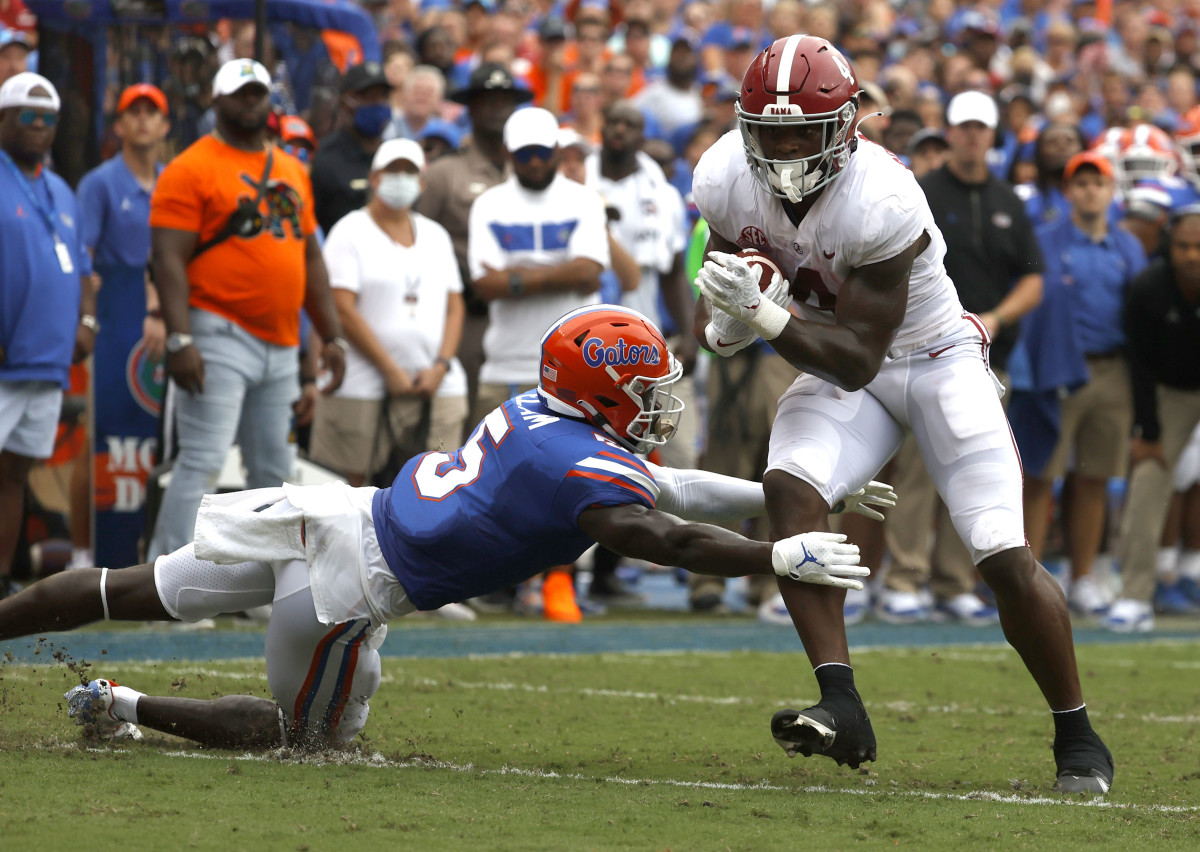 Sep 18, 2021; Gainesville, Florida, USA; Alabama Crimson Tide running back Brian Robinson Jr. (4) runs the ball in for a touchdown as Florida Gators cornerback Kaiir Elam (5) attempts to defend during the first half at Ben Hill Griffin Stadium. Mandatory Credit: Kim Klement-USA TODAY Sports