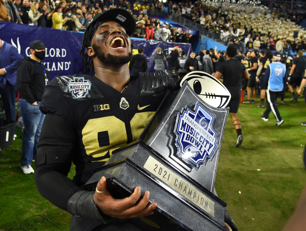 Lawrence Johnson celebrates with the Music City Bowl trophy.