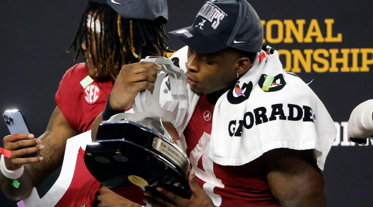 Alabama's Brian Robinson Jr. blows confetti off his outstanding offensive player trophy after the Cotton Bowl NCAA College Football Playoff semifinal game against Cincinnati, Friday, Dec. 31, 2021, in Arlington, Texas. Alabama won 27-6.