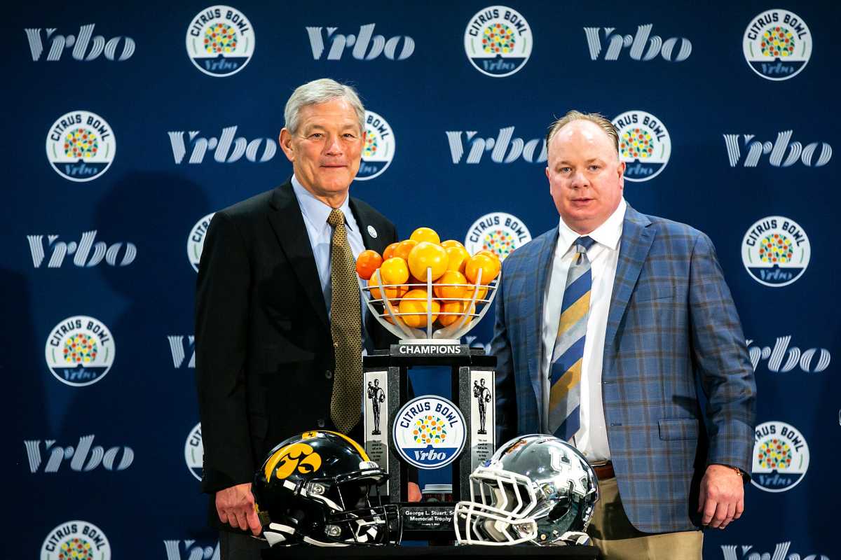 Iowa head coach Kirk Ferentz, left, and Kentucky head coach Mark Stoops pose for a photo with the trophy during a news conference for the Vrbo Citrus Bowl, Friday, Dec. 31, 2021, at the Rosen Plaza Hotel in Orlando, Fla. 211231 Citrus Iowa Kentucky Presser 012 Jpg