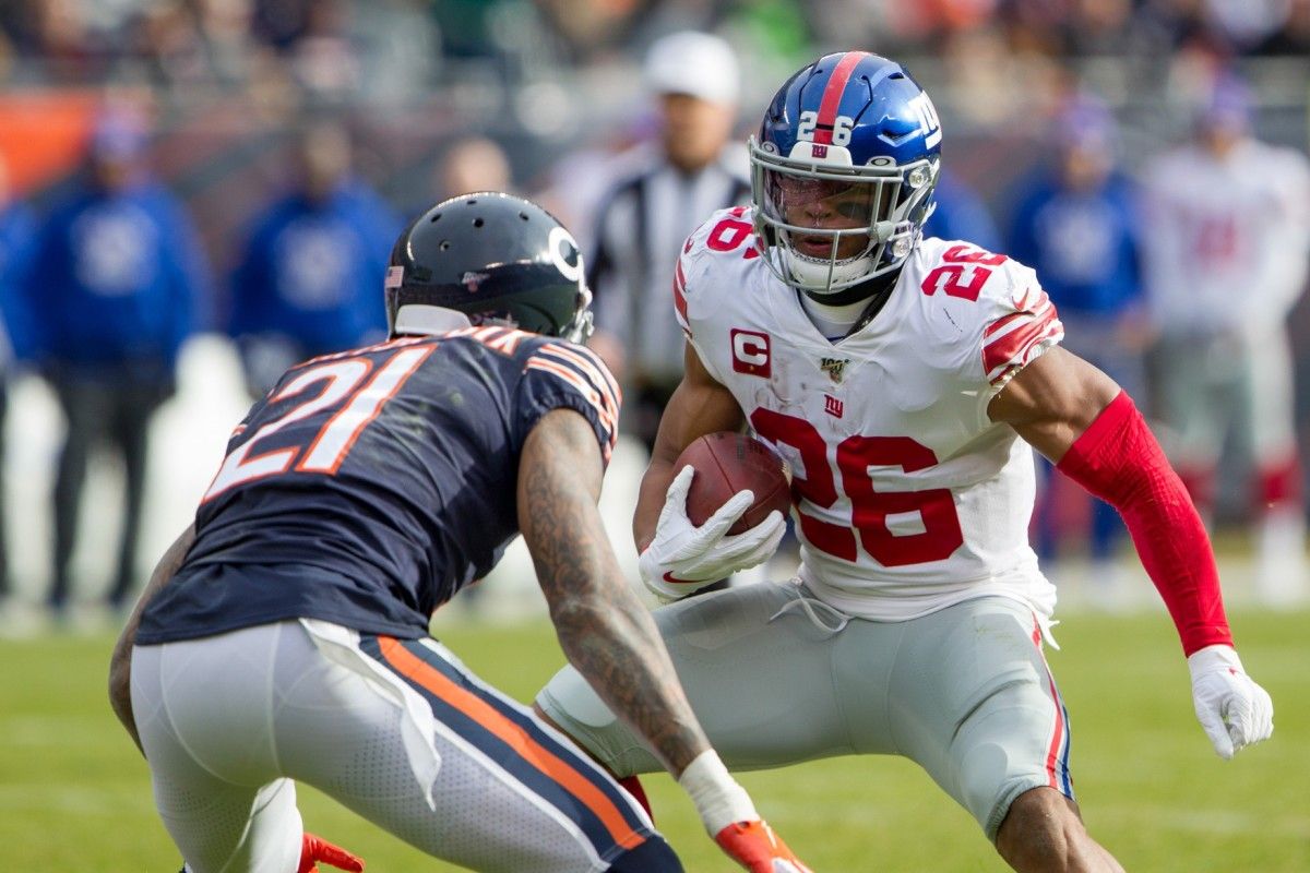 New York Giants running back Saquon Barkley (26) runs with the football against Chicago Bears strong safety Ha Ha Clinton-Dix (21) in the first quarter at Soldier Field.