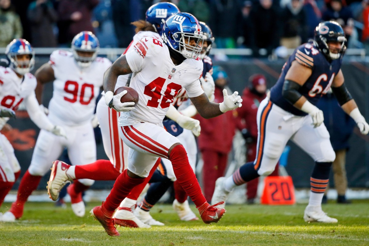 Jan 2, 2022; Chicago, Illinois, USA; New York Giants inside linebacker Tae Crowder (48) runs with the ball after making an interception against the Chicago Bears during the second half at Soldier Field.