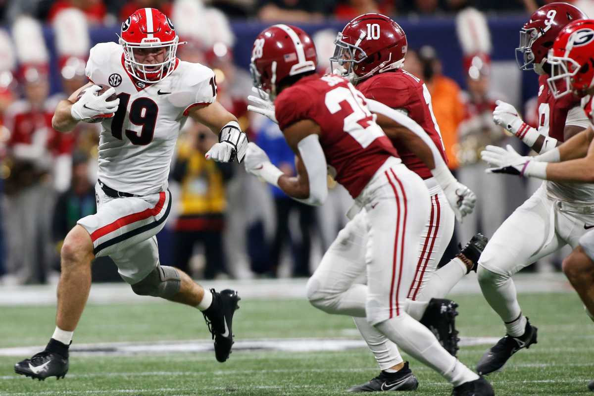 All American tight end Brock Bowers tries to evade a group of Alabama defenders in the SEC Championship Game.