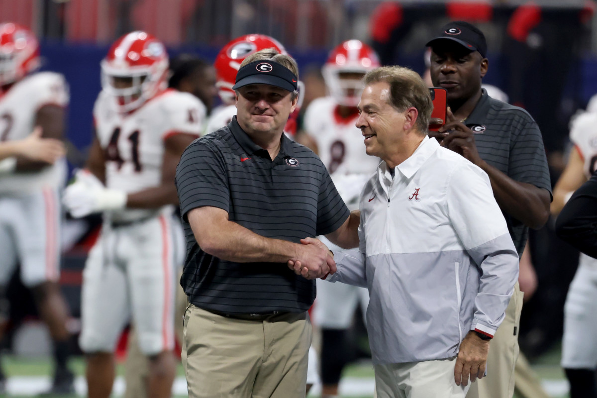 Nick Saban (right) meets with former assistant Kirby Smart (left) before December's SEC Championship.