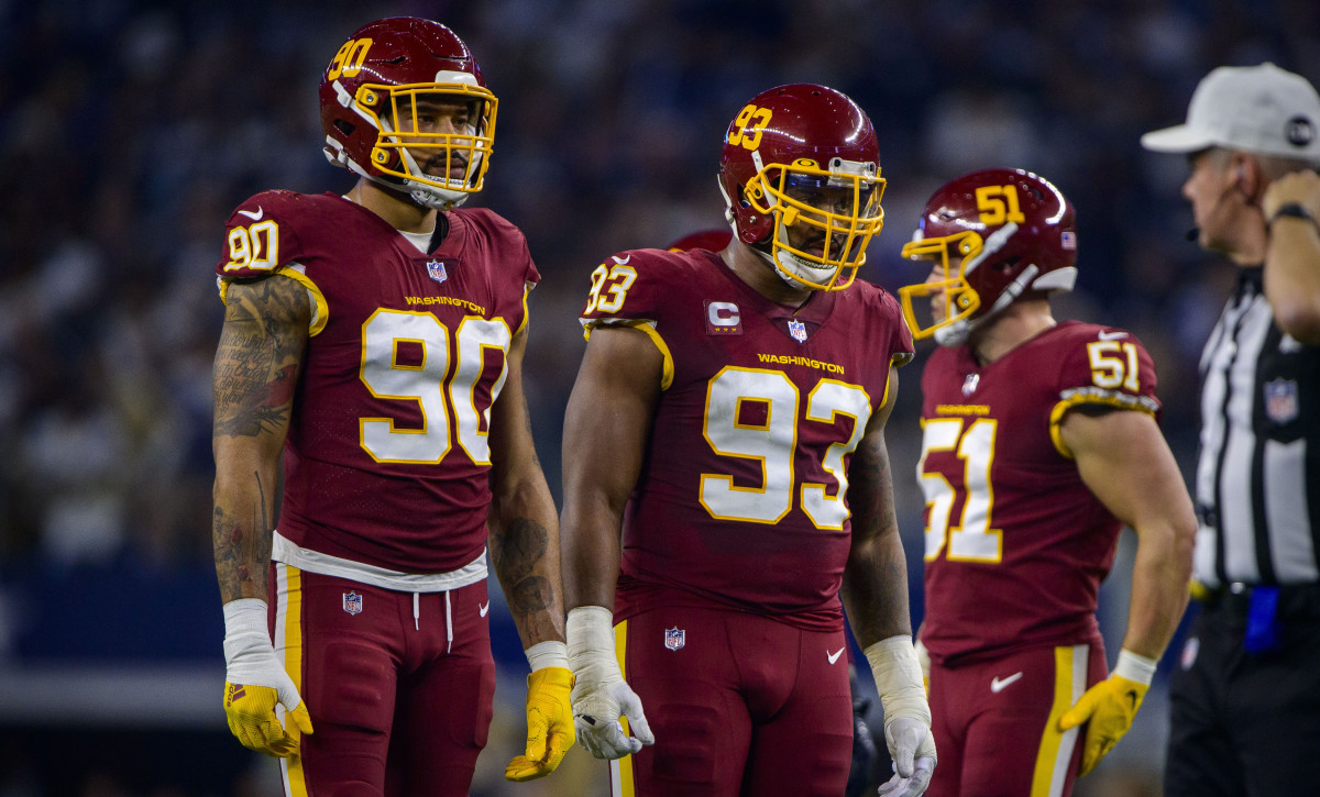 Washington Football Team defensive end Montez Sweat (90) and defensive tackle Jonathan Allen (93) wait for play to resume against the Dallas Cowboys at AT&T Stadium.