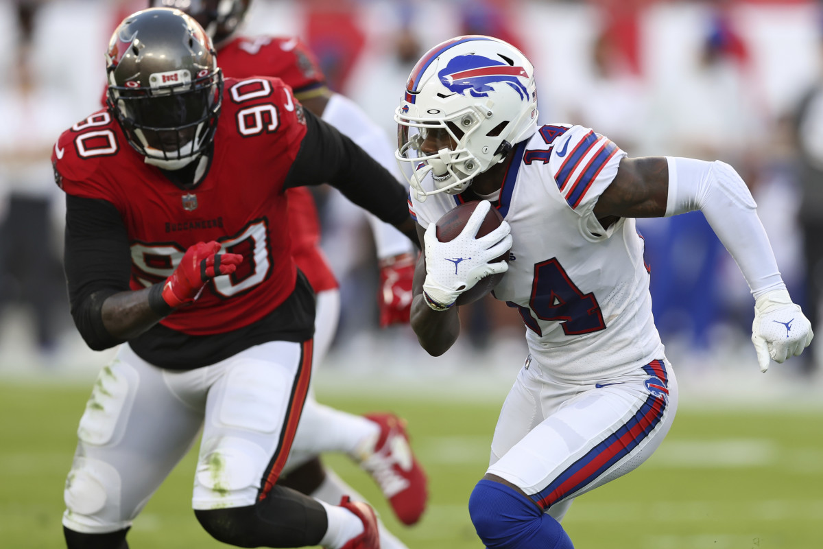 Buffalo Bills wide receiver Stefon Diggs (14) runs away from Tampa Bay Buccaneers linebacker Jason Pierre-Paul (90) after a catch during the first half of an NFL football game Sunday, Dec. 12, 2021, in Tampa, Fla.
