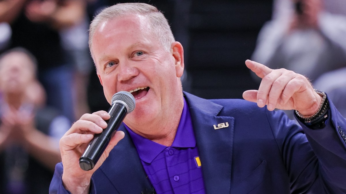 Brian Kelly talks during halftime at LSU basketball game.