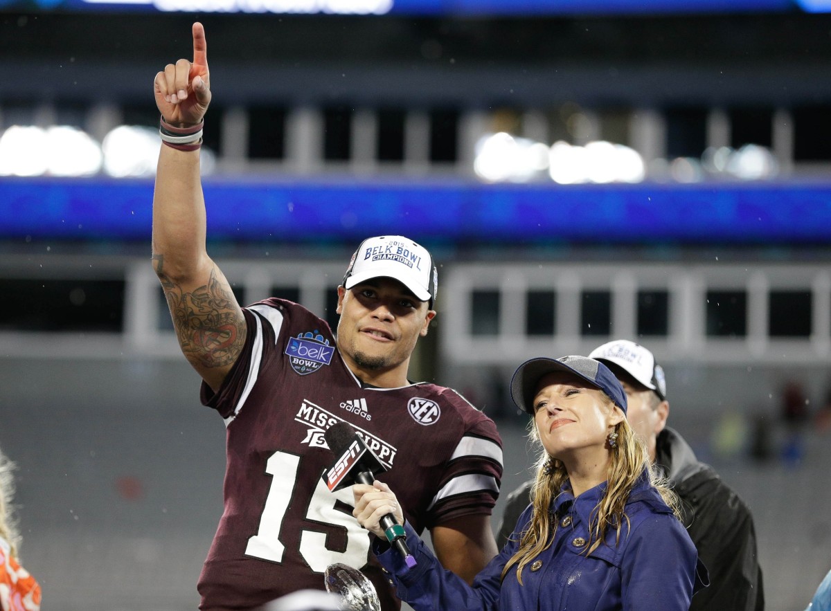 Mississippi State Bulldogs quarterback Dak Prescott (15) accepts the Belk Bowl MVP trophy after defeating the North Carolina State Wolfpack in the 2015 Belk Bowl at Bank of America Stadium. The Bulldogs defeated the Wolfpack 51-28. 