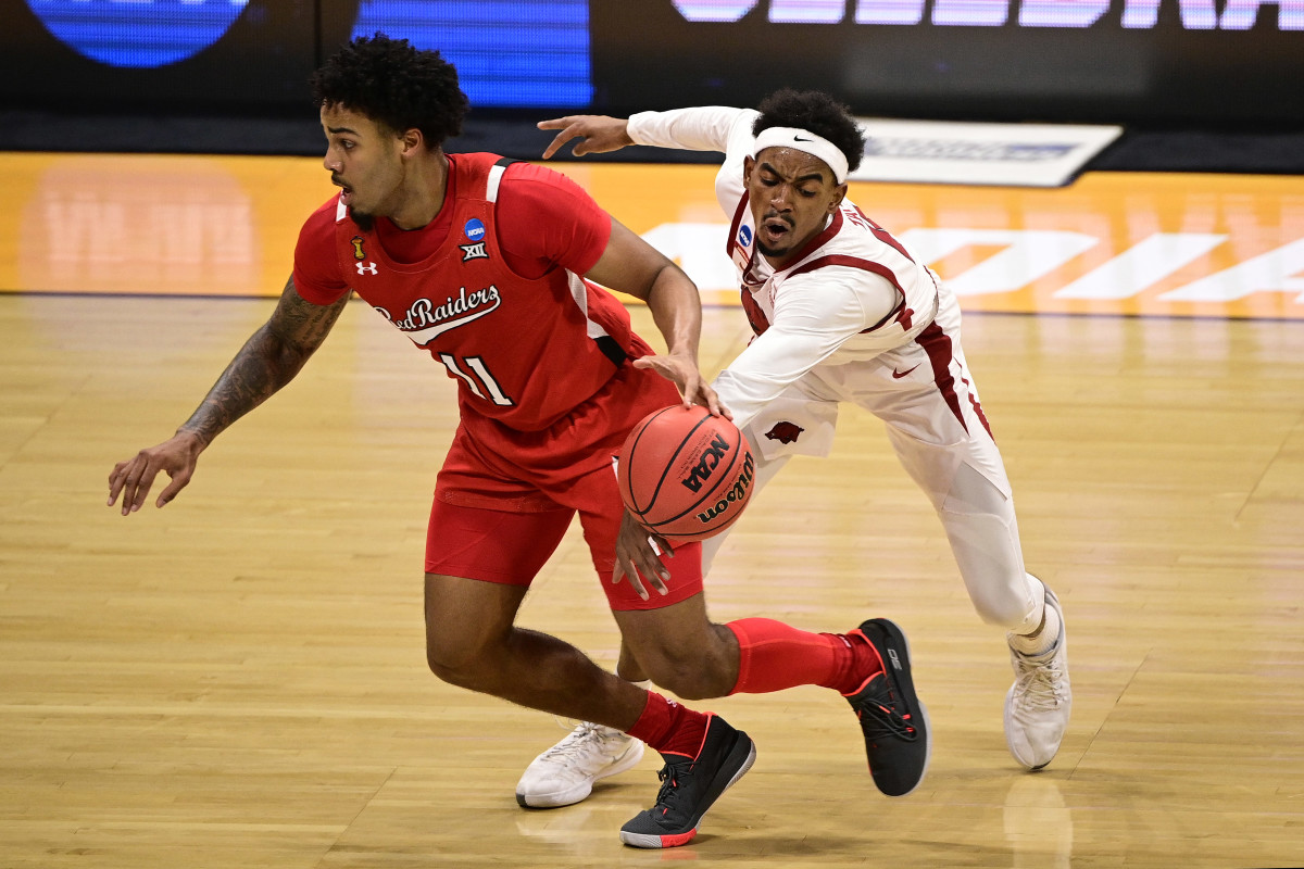 Arkansas Razorbacks guard Jalen Tate (11) defends against Texas Tech Red Raiders guard Kyler Edwards (11) in the first half in the second round of the 2021 NCAA Tournament at Hinkle Fieldhouse. 