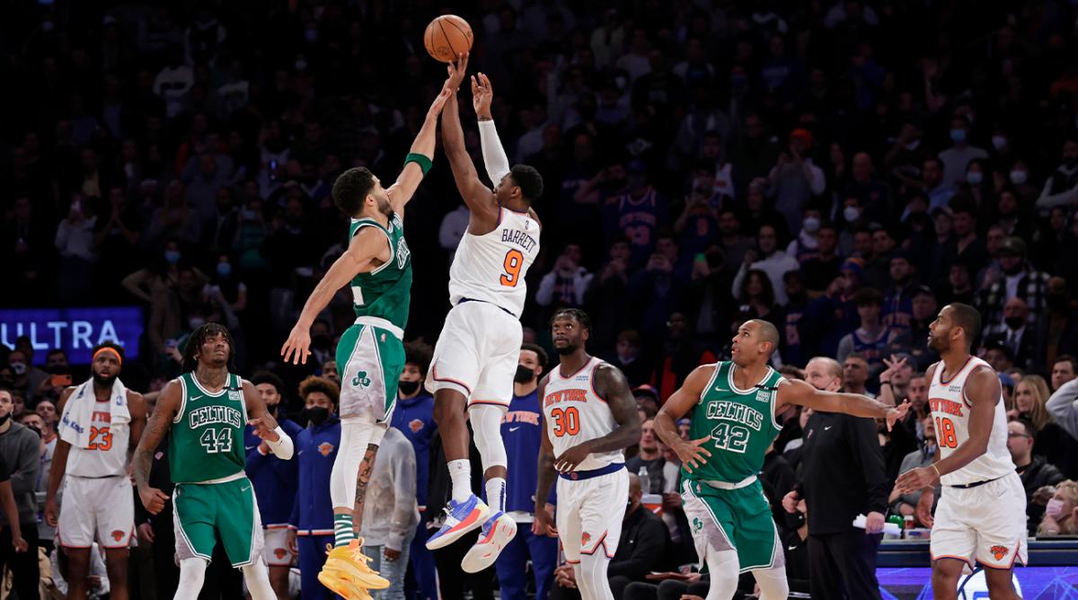 New York Knicks guard RJ Barrett (9) makes the game-winning 3-point basket in front of Boston Celtics forward Jayson Tatum during an NBA basketball game Thursday, Jan. 6, 2022, in New York. The Knicks won 108-105.