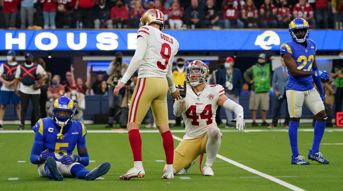 San Francisco 49ers kicker Robbie Gould (9) celebrates with fullback Kyle Juszczyk (44) after making a field goal in overtime of an NFL football game against the Los Angeles Rams, Sunday, Jan. 9, 2022, in Inglewood, Calif. Rams cornerback Jalen Ramsey (5) and defensive back David Long (22) react.