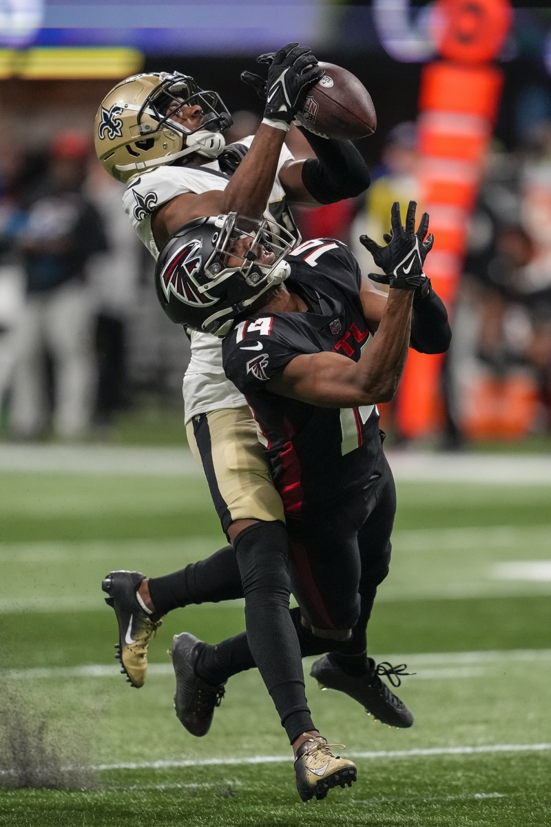 New Orleans Saints cornerback Paulson Adebo (29) breaks up a pass over Falcons receiver Russell Gage (14). Mandatory Credit: Dale Zanine-USA TODAY Sports