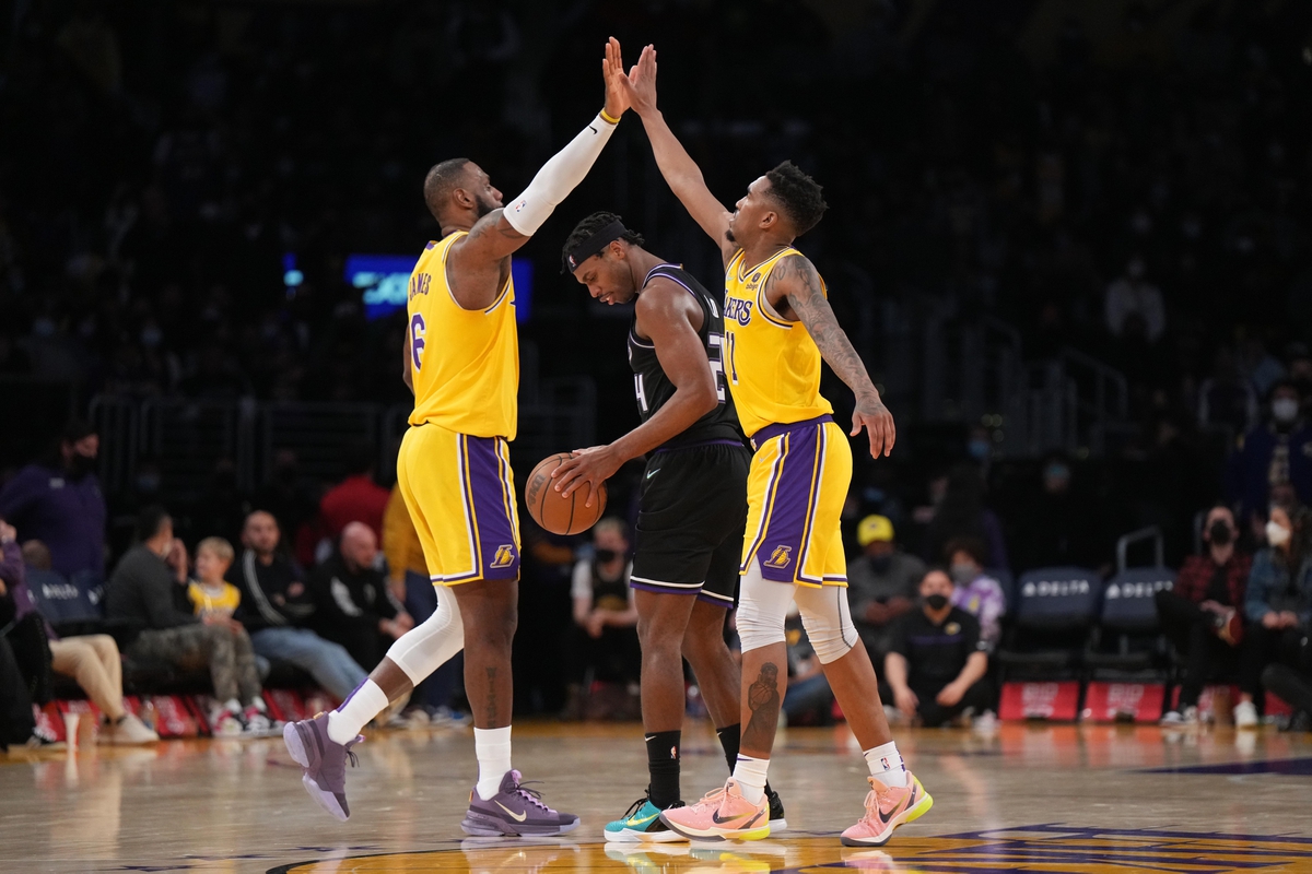 Jan 4, 2022; Los Angeles, California, USA; Los Angeles Lakers forward LeBron James (6) celebrates with guard Russell Westbrook (0) as Sacramento Kings guard Buddy Hield (24) reacts in the second half at Crypto.com Arena. Mandatory Credit: Kirby Lee-USA TODAY Sports