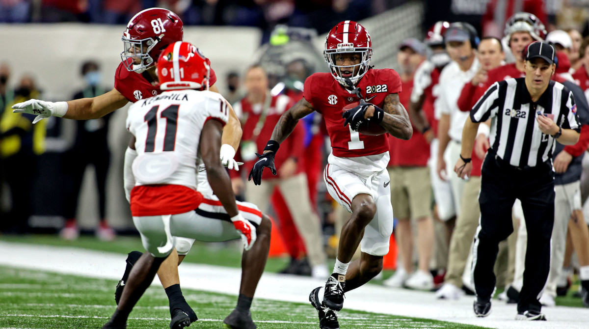 Jan 10, 2022; Indianapolis, IN, USA; Alabama Crimson Tide wide receiver Jameson Williams (1) runs the ball against Georgia Bulldogs defensive back Derion Kendrick (11) during the first quarter in the 2022 CFP college football national championship game at Lucas Oil Stadium.