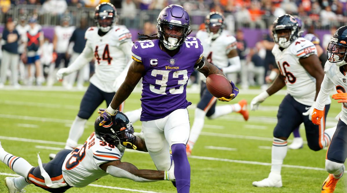 Minnesota Vikings running back Dalvin Cook (33) tries to break a tackle by Chicago Bears safety Tashaun Gipson, left, during the second half of an NFL football game, Sunday, Jan. 9, 2022, in Minneapolis.