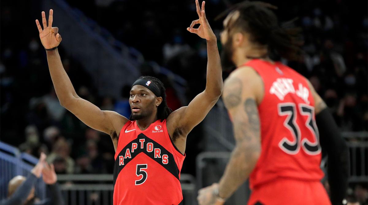 Toronto Raptors' Precious Achiuwa (5) gestures after a made 3-point basket by Gary Trent Jr. (33) during the second half of an NBA basketball game against the Milwaukee Bucks, Wednesday, Jan. 5, 2022, in Milwaukee.