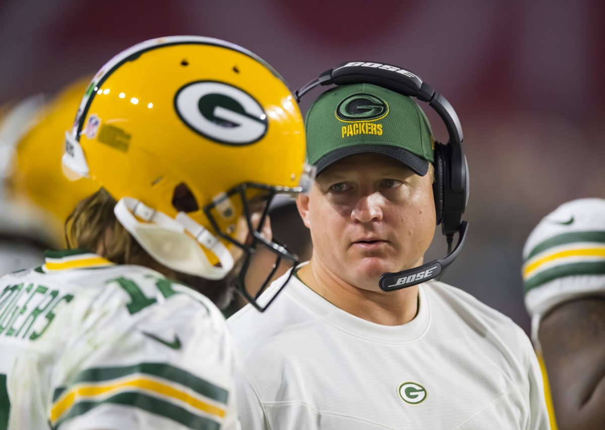 Green Bay Packers quarterbacks coach Luke Getsy talks to Aaron Rodgers (12) against the Arizona Cardinals at State Farm Stadium.