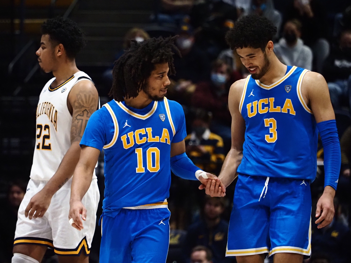 Jan 8, 2022; Berkeley, California, USA; UCLA Bruins guard Tyger Campbell (10) celebrates with guard Johnny Juzang (3) in the final seconds of the game against the California Golden Bears during the second half at Haas Pavilion. Mandatory Credit: Kelley L Cox-USA TODAY Sports