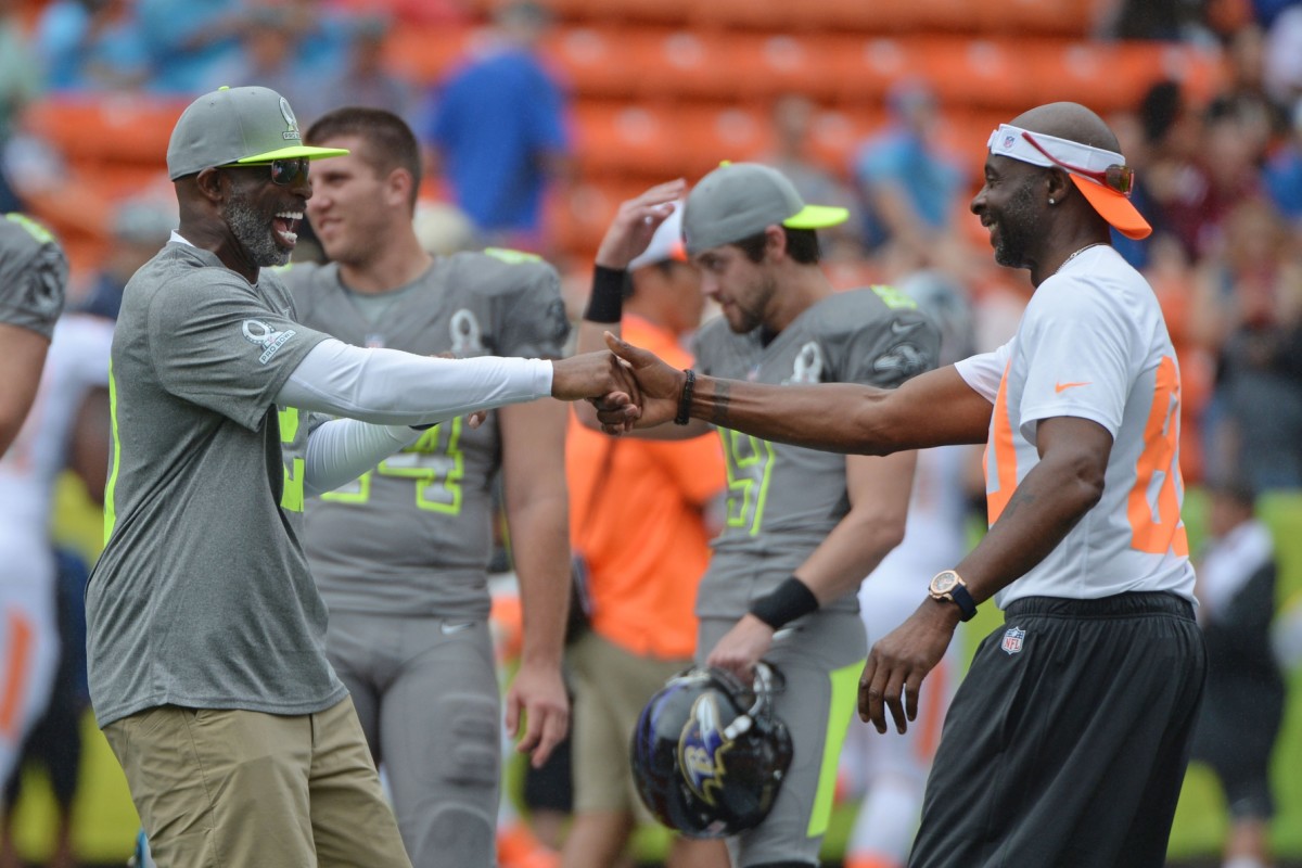 Team Sanders alumni captain Deion Sanders shakes hands with Team Rice alumni captain Jerry Rice AY Sports