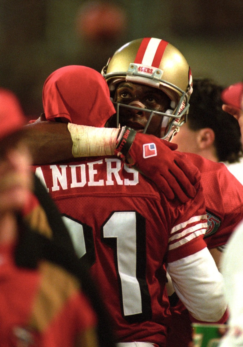 San Francisco 49ers cornerback Deion Sanders (21) receives a hug from receiver Jerry Rice (80)