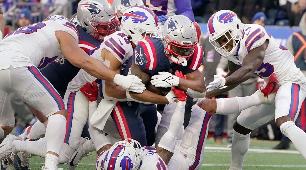 New England Patriots running back Damien Harris (37) drives through the Buffalo Bills for his third touchdown of the day during the second half of an NFL football game, Sunday, Dec. 26, 2021, in Foxborough, Mass.