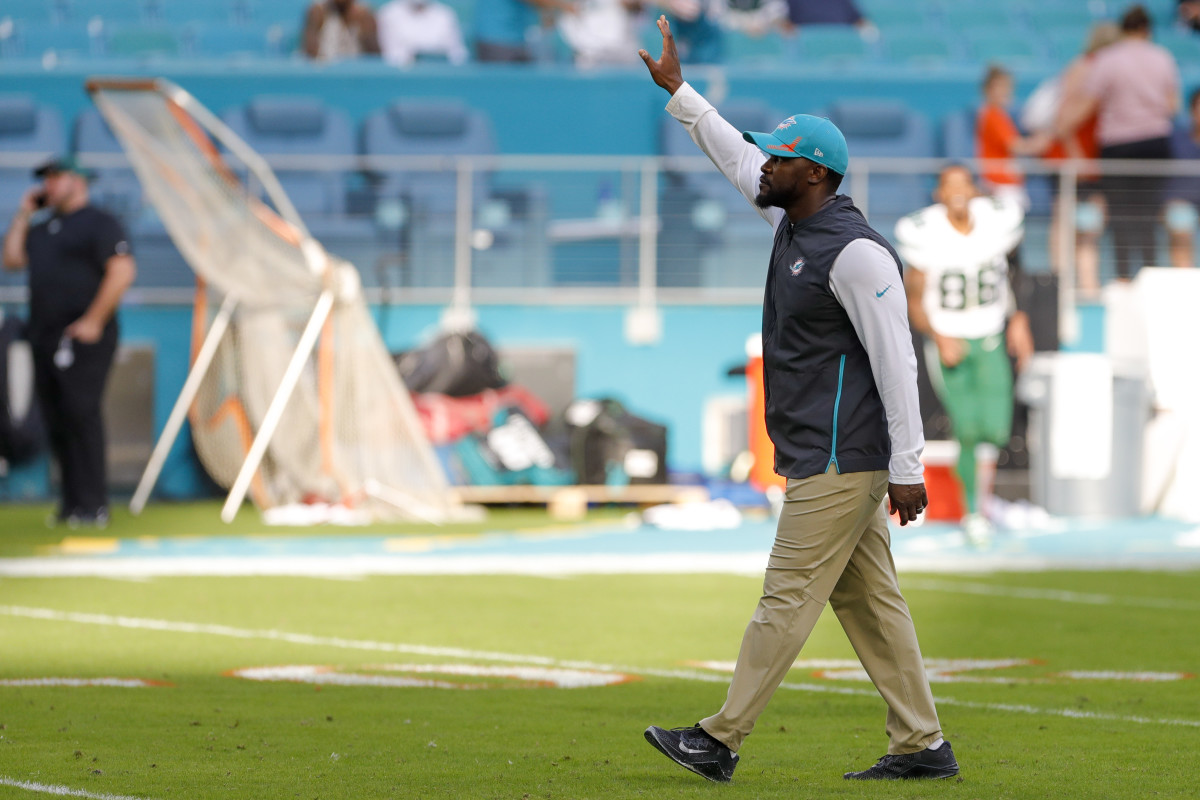 Miami Dolphins head coach Brian Flores waves at fans after winning the game against the New York Jets at Hard Rock Stadium.