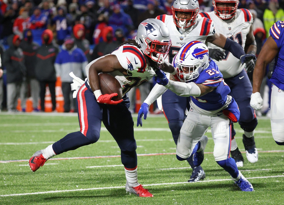 Patriots running back Rhamondre Stevenson is tackled by Bills Jordon Poyer after a short gain. New England ran the ball 47 times in a 14-10 win.