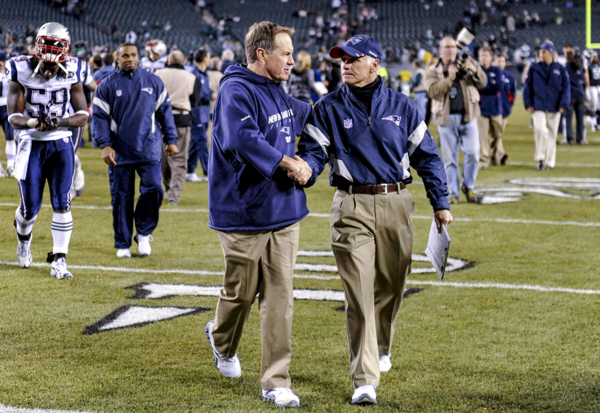 Bill Belichick and Dante Scarnecchia walk off the field following a Patriots win in 2011