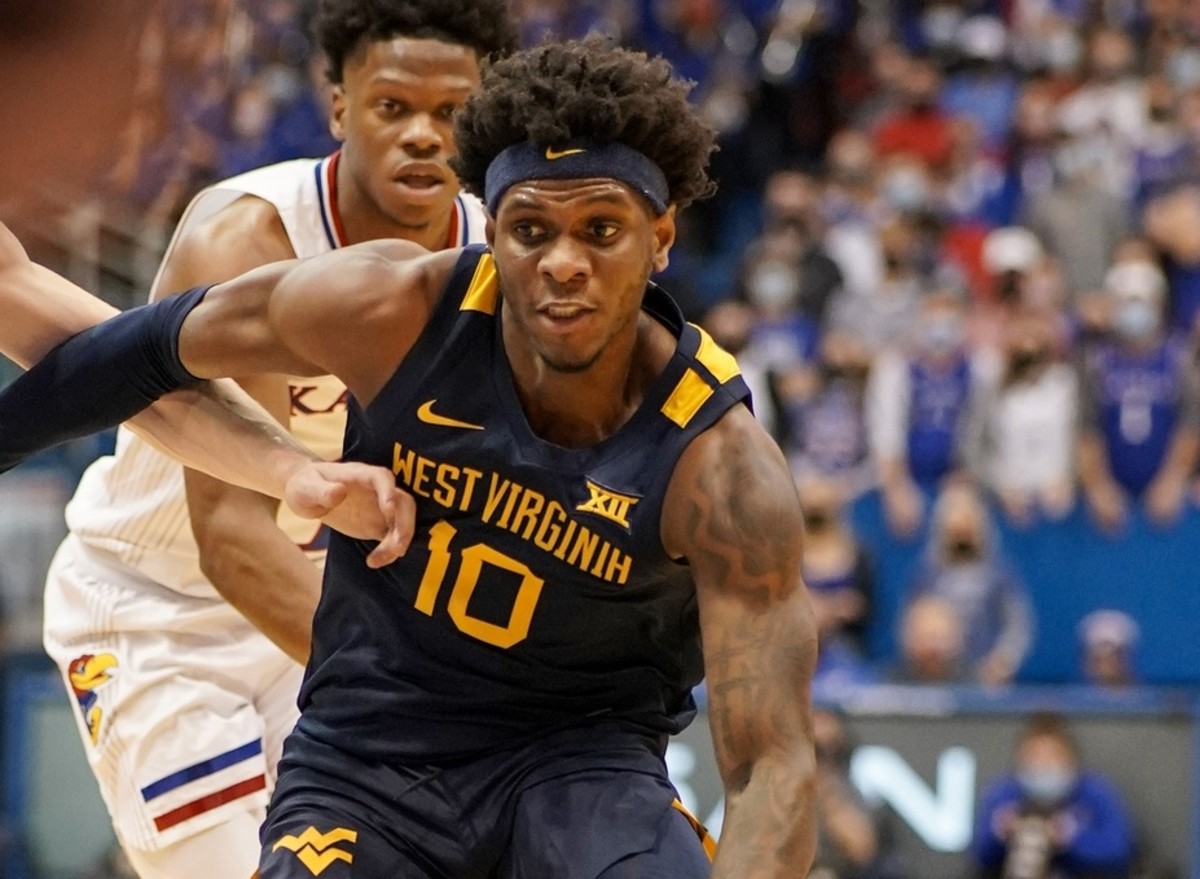 Jan 15, 2022; Lawrence, Kansas, USA; West Virginia Mountaineers guard Malik Curry (10) dribbles the ball against the Kansas Jayhawks during the first half at Allen Fieldhouse.