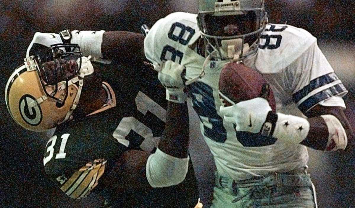 Dallas Cowboys receiver Michael Irvin stiff-arms Green Bay Packers safety George Teague after catching a 40-yard pass in the 1995 NFC Championship Game. The Cowboys won the game,