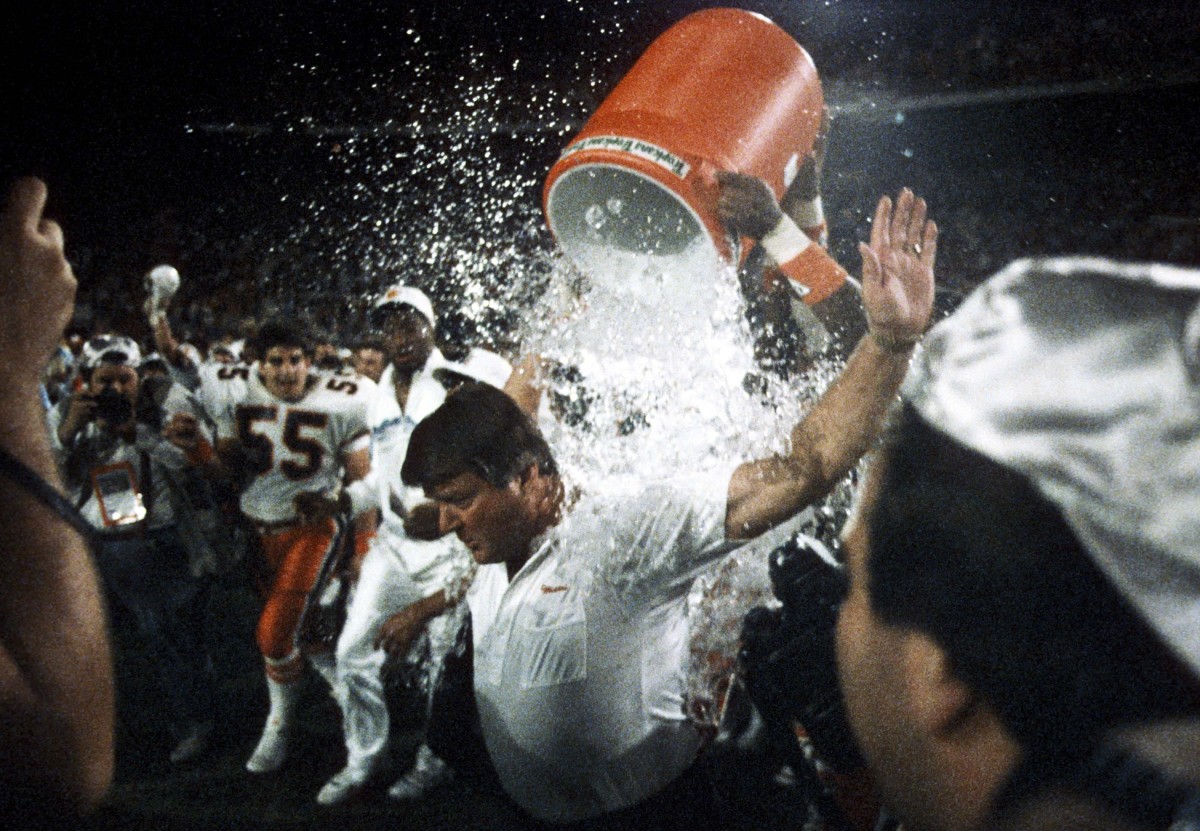 Miami Hurricanes head coach Jimmy Johnson gets a celebratory shower from his players after defeating the Nebraska Cornhuskers in the 1989 Orange Bowl 23-3.
