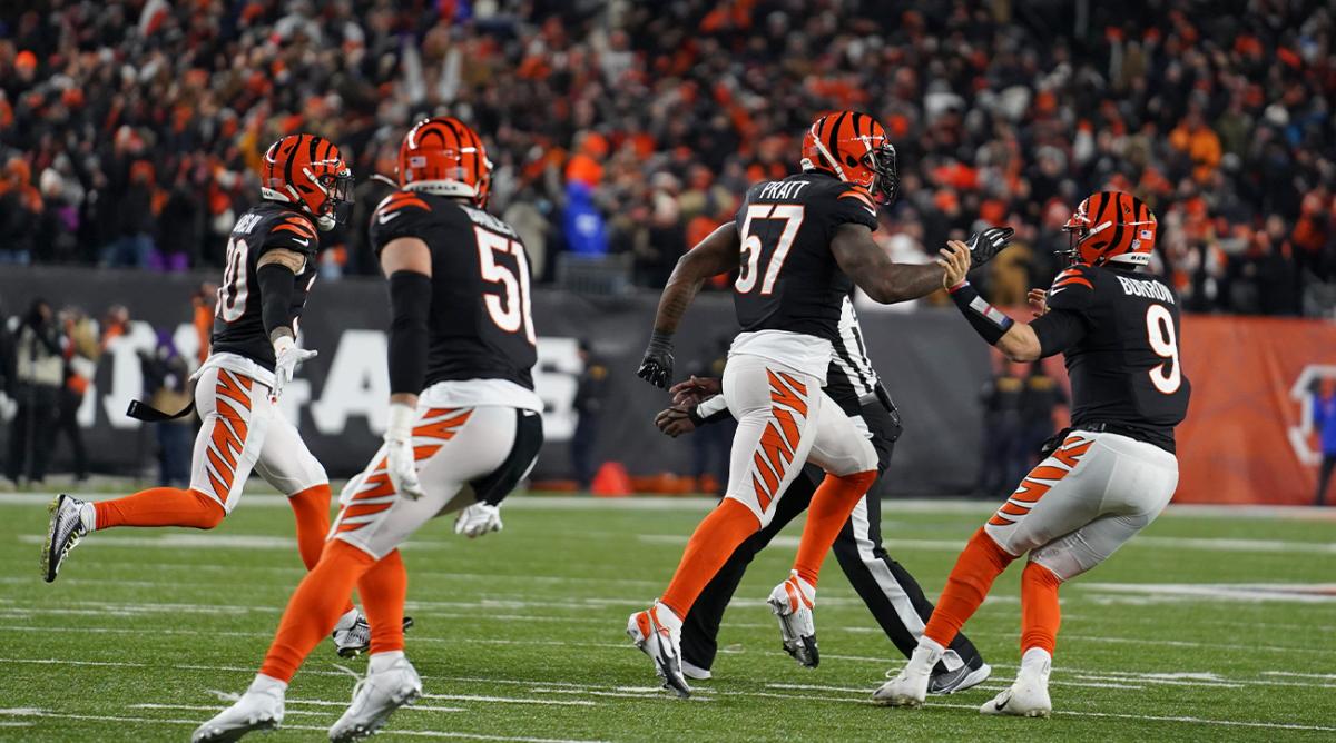 Cincinnati Bengals' Germaine Pratt (57) celebrate with quarterback Joe Burrow (9) after Pratt made an interception during the second half of an NFL wild-card playoff football game against the Las Vegas Raiders, Saturday, Jan. 15, 2022, in Cincinnati. Cincinnati won 26-19.