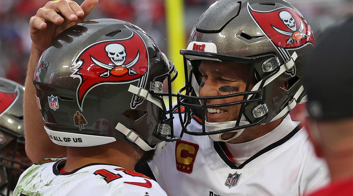 Tampa Bay Buccaneers quarterback Tom Brady, right, celebrates with wide receiver Mike Evans after Evans caught a touchdown pass against the Philadelphia Eagles during the second half of an NFL wild-card football game Sunday, Jan. 16, 2022, in Tampa, Fla.