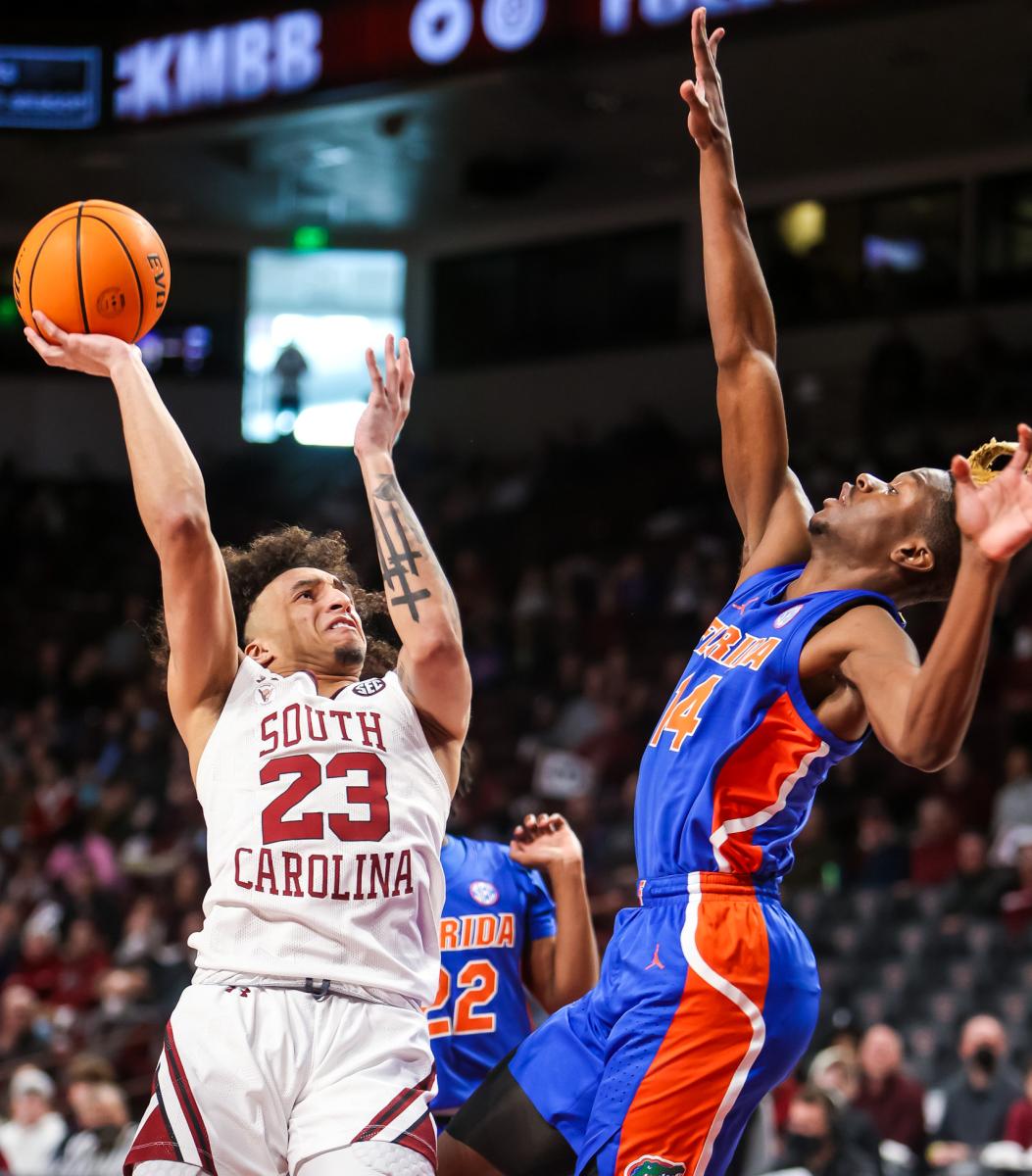 South Carolina Gamecocks guard Devin Carter (23) shoots over Florida Gators guard Kowacie Reeves (14) in the first half at Colonial Life Arena.
