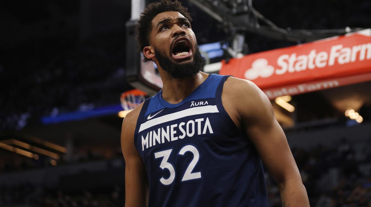 Minnesota Timberwolves center Karl-Anthony Towns (32) reacts after scoring a basket during the first half of an NBA basketball game against the Golden State Warriors, Sunday Jan. 16, 2022, in Minneapolis.