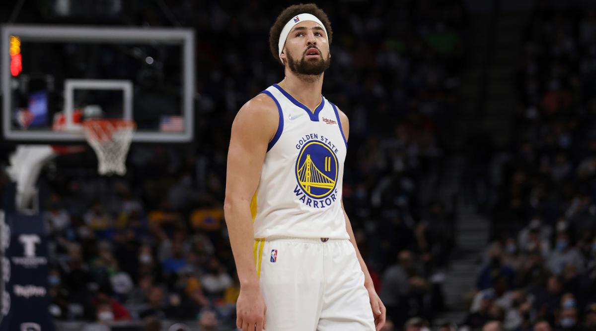 Golden State Warriors guard Klay Thompson (11) walks on the court during the first half of an NBA basketball game against the Golden State Warriors, Sunday Jan. 16, 2022, in Minneapolis.